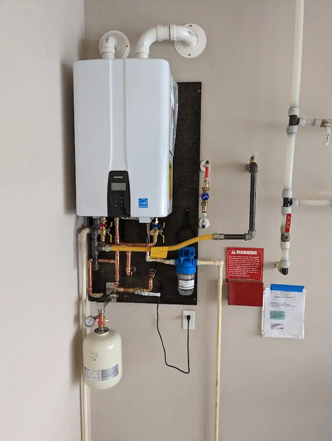 Professional plumber installing copper piping in a North Shore home